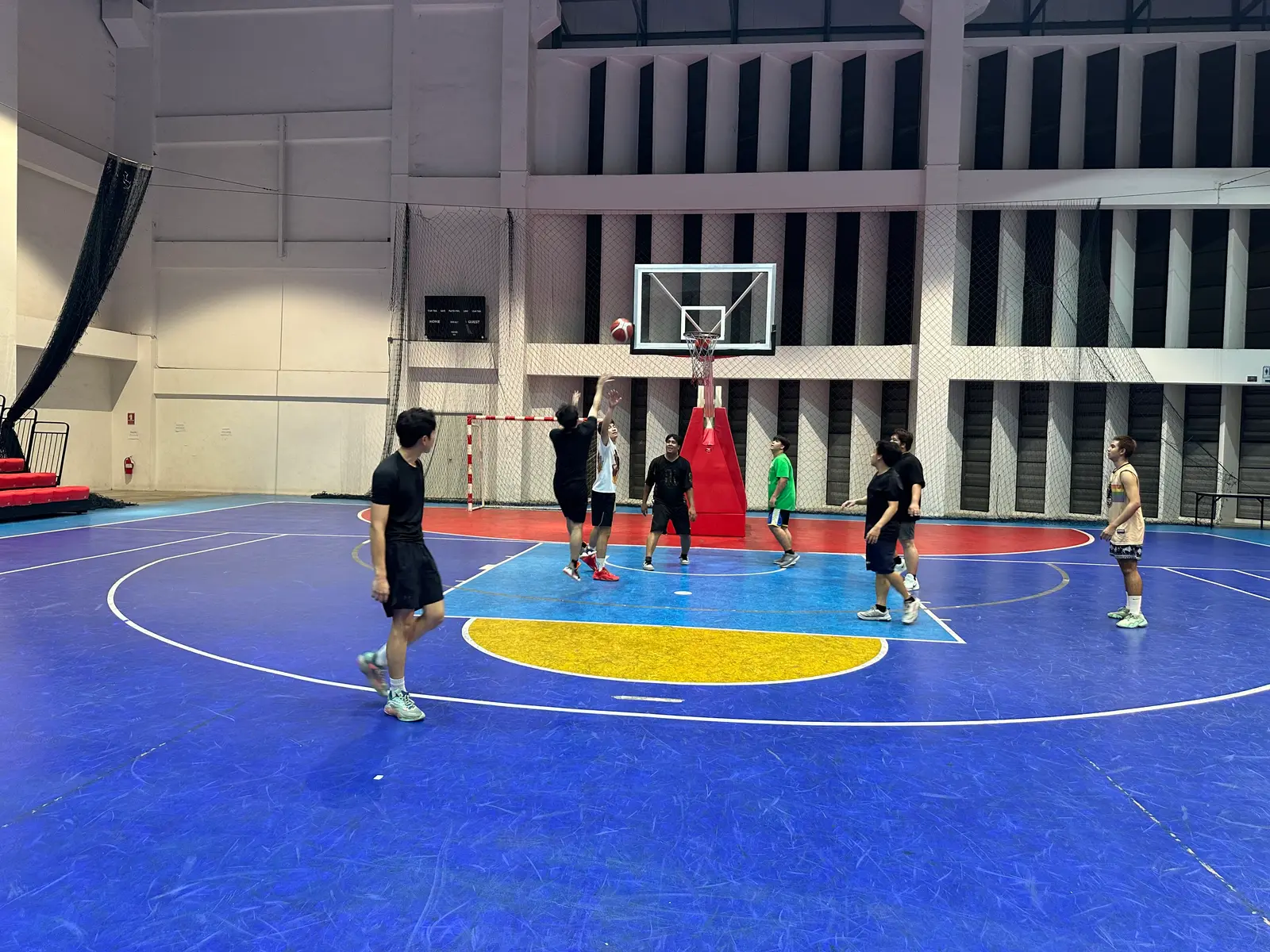 A game in progress under the basket