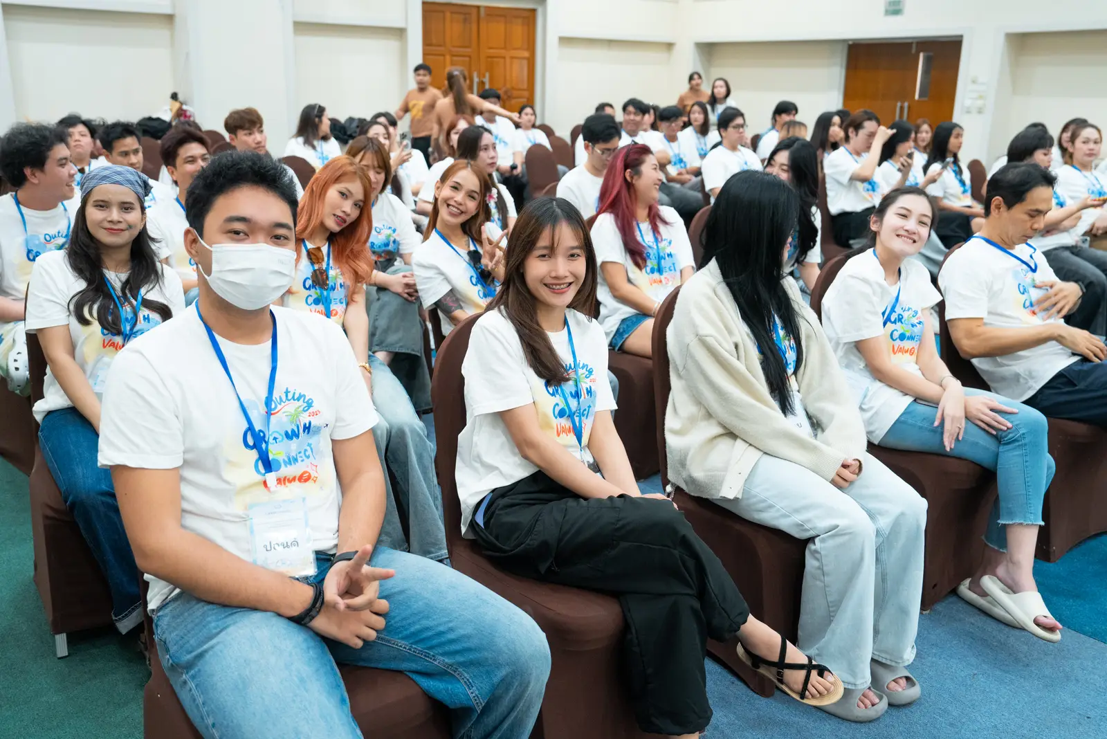 Colleagues in matching tees listen during a session