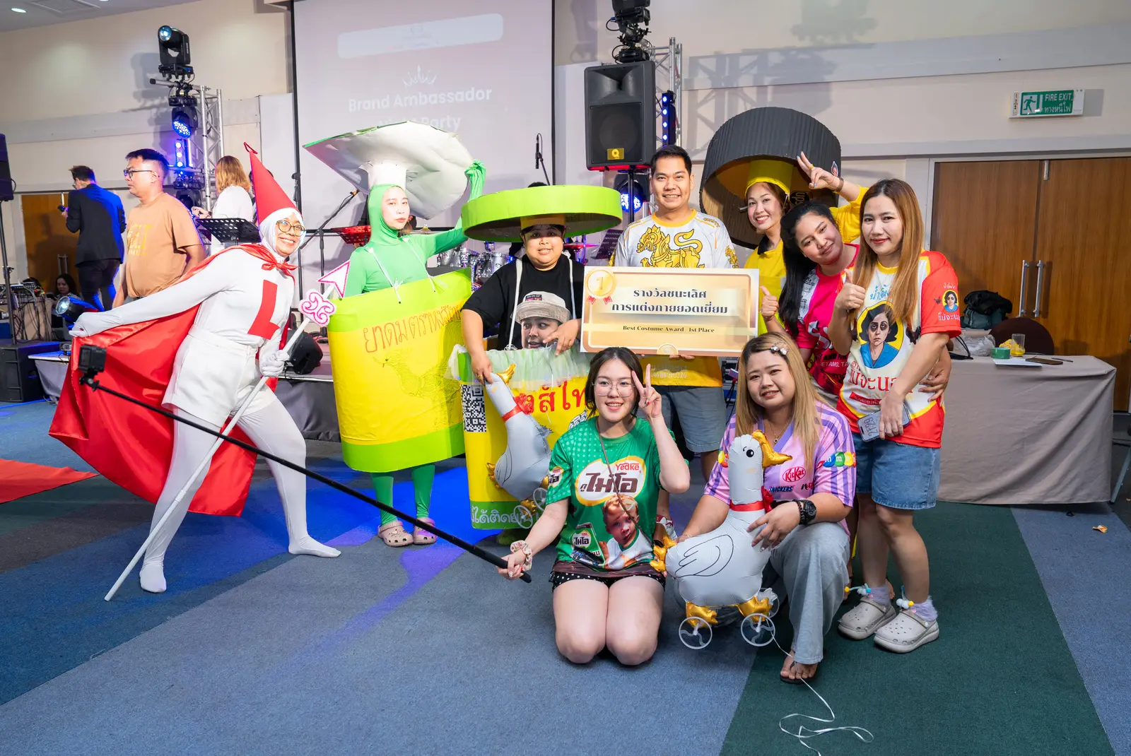 A costumed team poses with its prize on stage