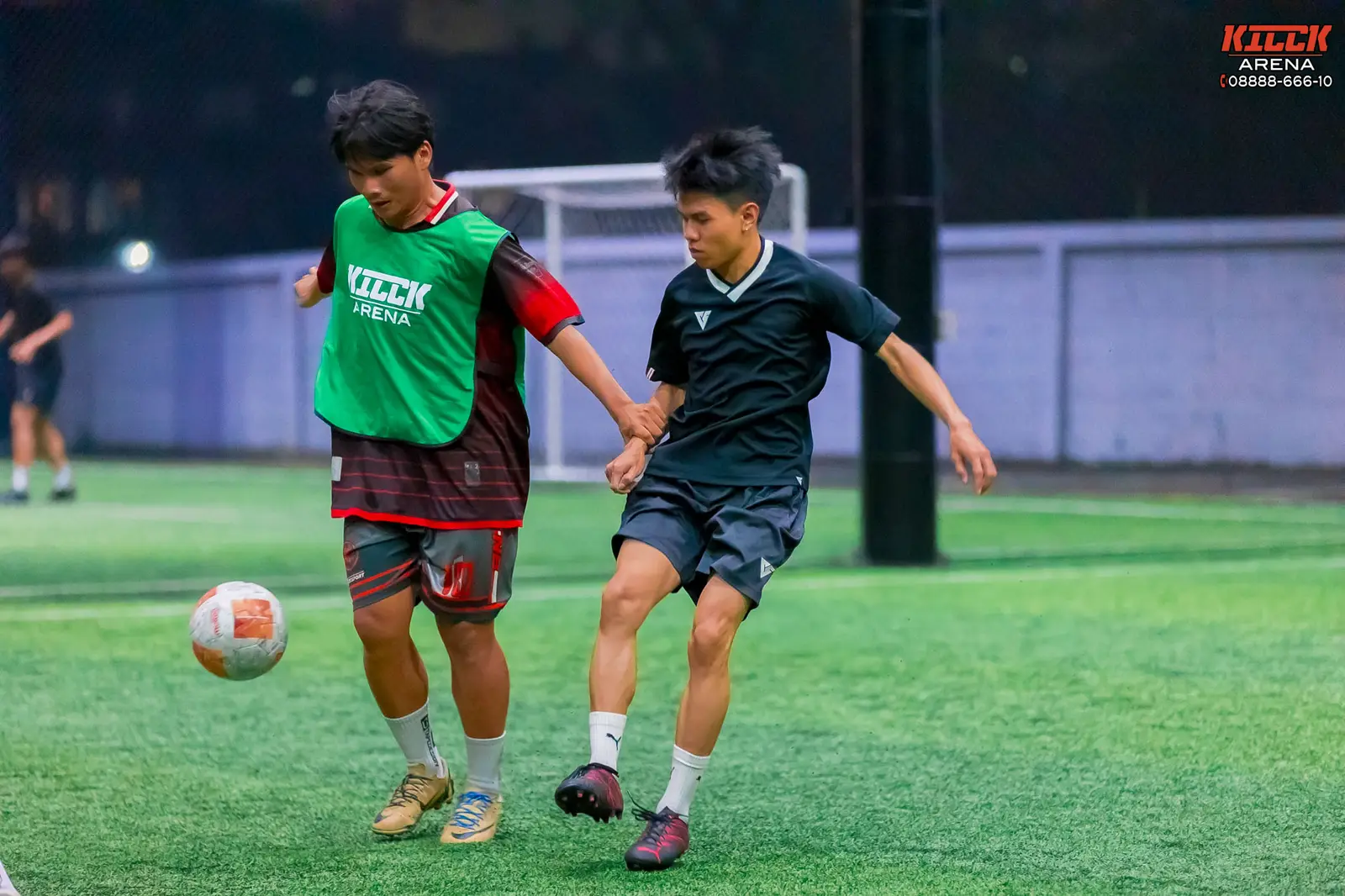 Two players fight for the ball