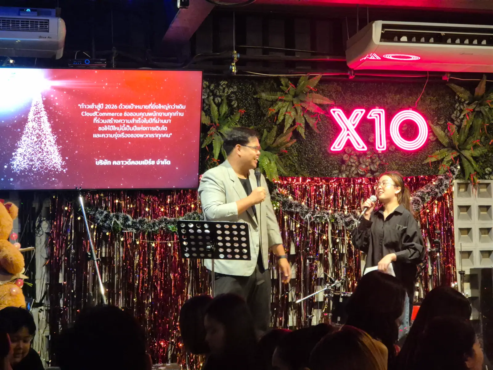 Hosts on stage welcome everyone