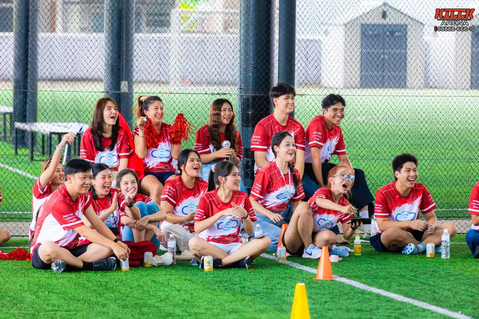 The red team cheers from the sideline